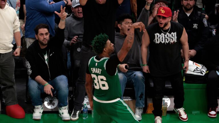 Marcus Smart celebrates near the sideline after hitting a three for the Celtics.