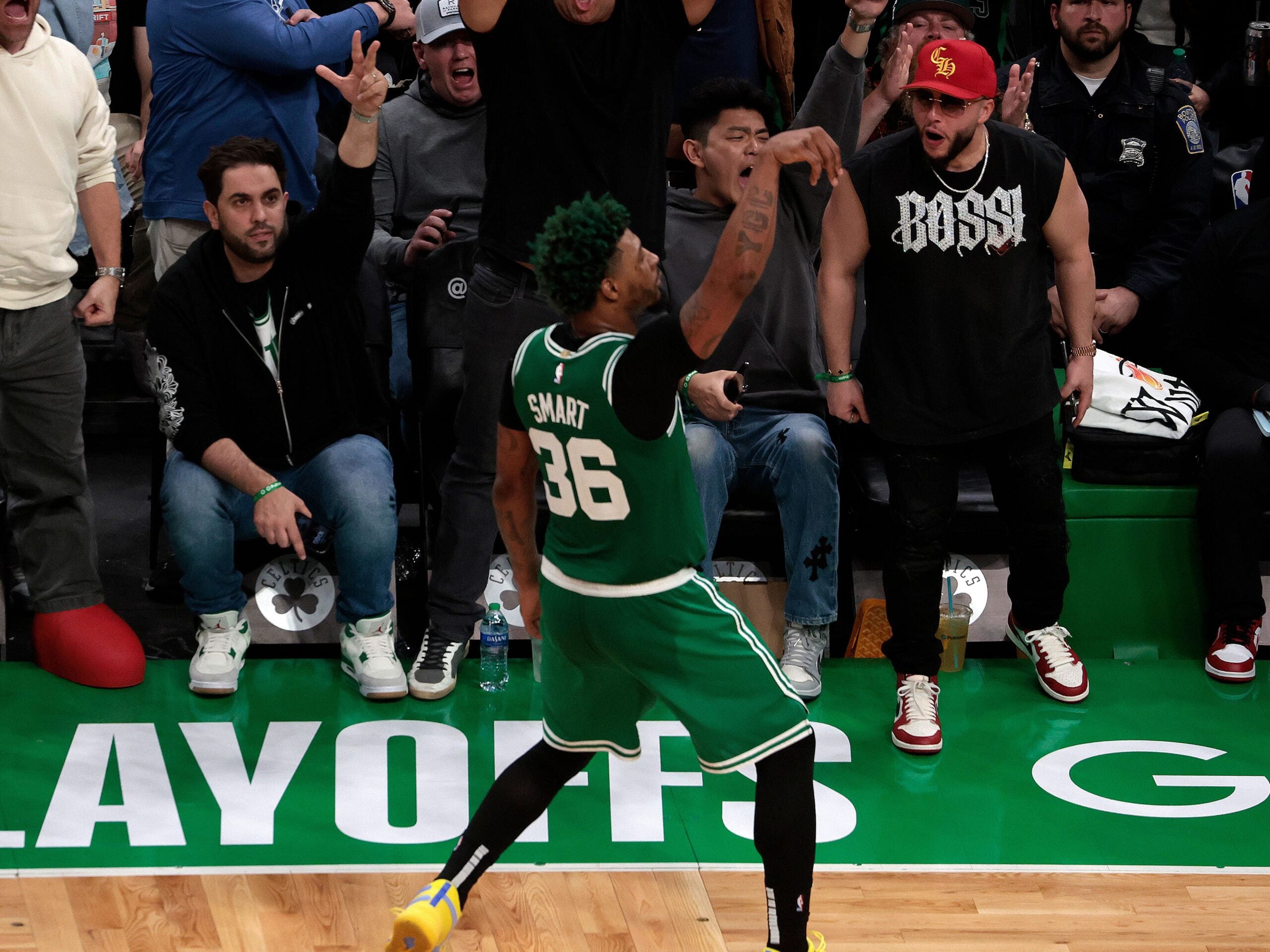 Marcus Smart celebrates near the sideline after hitting a three for the Celtics.