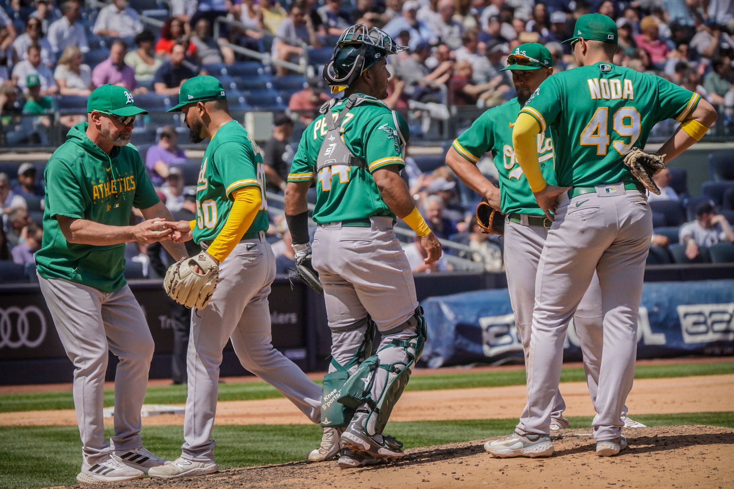 Oakland A's pitcher Rico Garcia, second from left, is pulled after giving up a grand slam home run during the fifth inning of a baseball game against the New York Yankees.