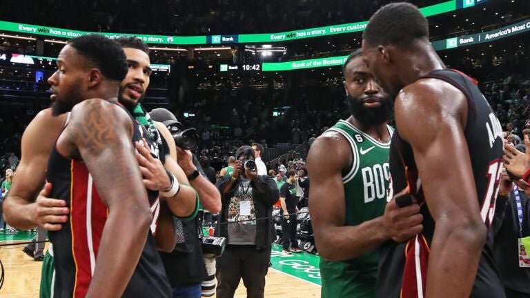 Jaylen Brown and Jayson Tatum embrace Heat players after the Celtics are eliminated.