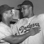 Brooklyn Dodgers catcher Roy Campanella, left, congratulates his battery mate, Don Newcombe, in the dressing room at the Polo Grounds in New York on Sept. 2, 1949.