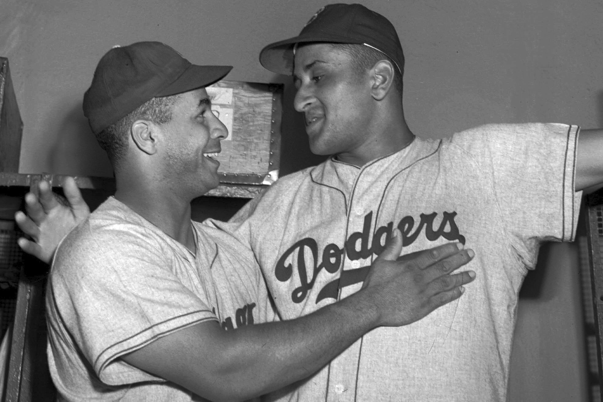 Brooklyn Dodgers catcher Roy Campanella, left, congratulates his battery mate, Don Newcombe, in the dressing room at the Polo Grounds in New York on Sept. 2, 1949.
