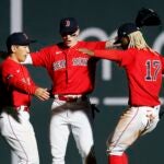 Masataka Yoshida, Jarren Duran and Raimel Tapia celebrate after defeating the Blue Jays.