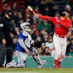 Boston Red Sox's Masataka Yoshida flies out in front of Toronto Blue Jays' Alejandro Kirk during the third inning of a baseball game, Wednesday, May 3, 2023, in Boston.