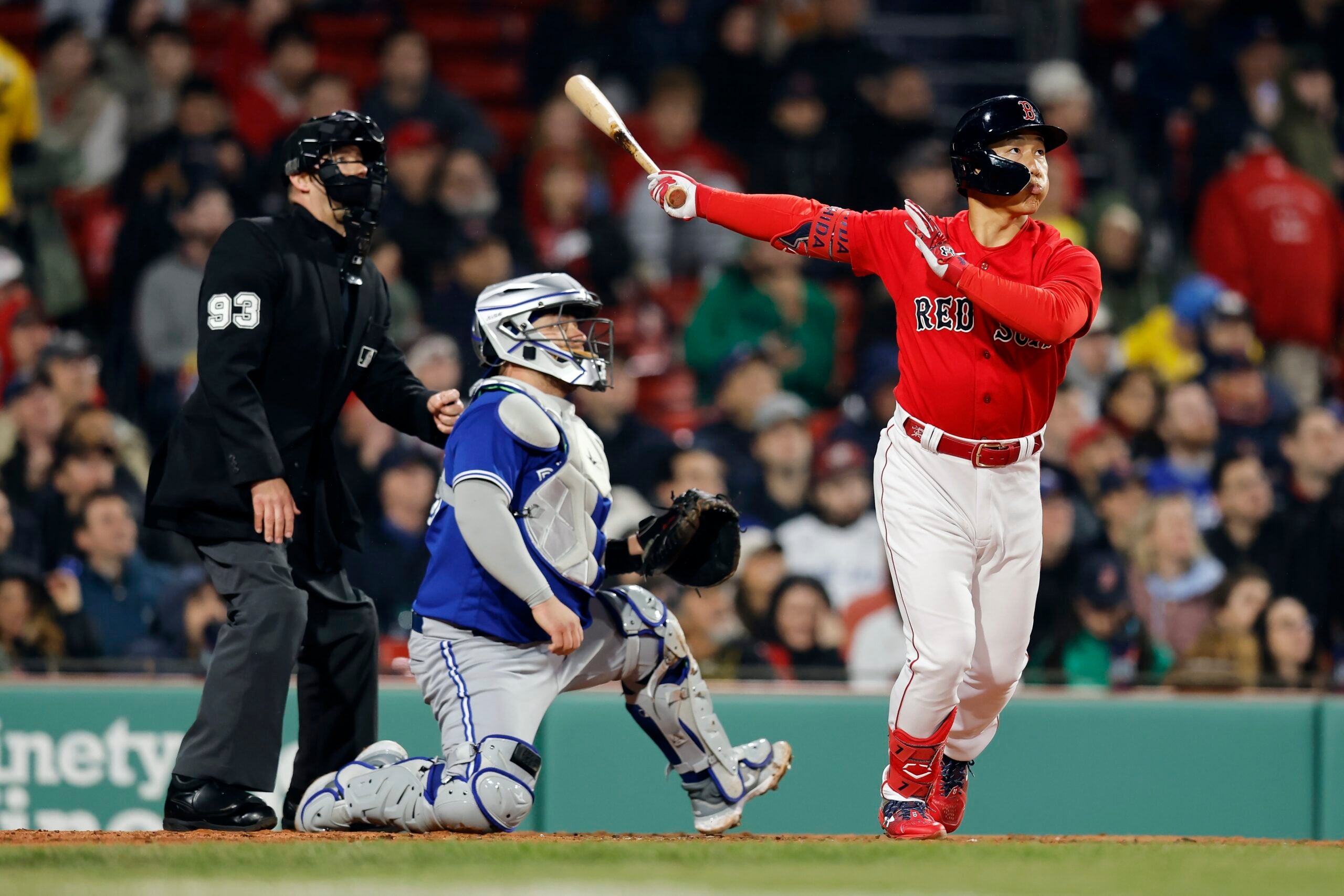 Boston Red Sox's Masataka Yoshida flies out in front of Toronto Blue Jays' Alejandro Kirk during the third inning of a baseball game, Wednesday, May 3, 2023, in Boston.