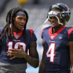 Houston Texans wide receiver DeAndre Hopkins. left, talks with quarterback Deshaun Watson before an NFL football game.