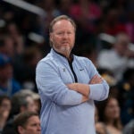 Former Milwaukee Bucks head coach, Mike Budenholzer looks on from the sideline during a game.