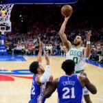 Boston Celtics' Jayson Tatum shoots against Philadelphia 76ers' Tobias Harris, left, and Joel Embiid during the first half of Game 6 of an NBA basketball playoffs Eastern Conference semifinal, Thursday, May 11, 2023, in Philadelphia.
