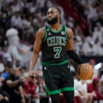 Boston Celtics guard Jaylen Brown (7) dribbles the ball during Game 3 of the NBA basketball playoffs Eastern Conference finals against the Miami Heat, Sunday, May 21, 2023, in Miami.