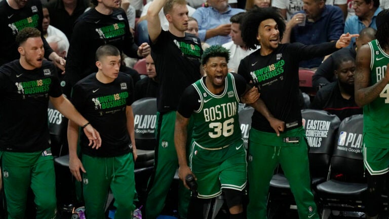 Celtics players cheer during the second half of Game 4.