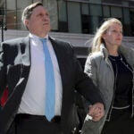 John Wilson arrives at federal court with his wife Leslie, April 3, 2019, to face charges in a nationwide college admissions bribery scandal, in Boston.