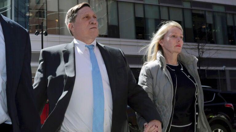 John Wilson arrives at federal court with his wife Leslie, April 3, 2019, to face charges in a nationwide college admissions bribery scandal, in Boston.