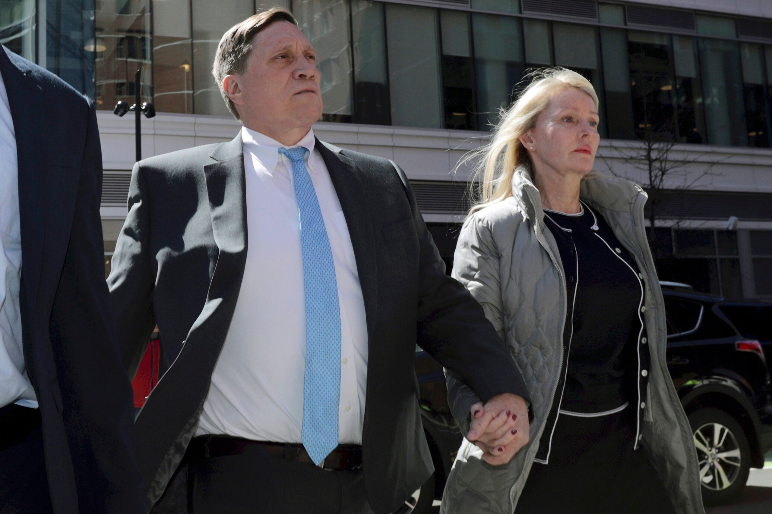 John Wilson arrives at federal court with his wife Leslie, April 3, 2019, to face charges in a nationwide college admissions bribery scandal, in Boston.