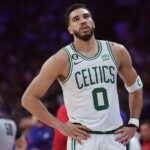 Celrics forward Jayson Tatum sighs on the court.