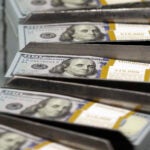 Debt limit -- FILE - Cut stacks of $100 bills make their way down the line at the Bureau of Engraving and Printing Western Currency Facility in Fort Worth, Texas.