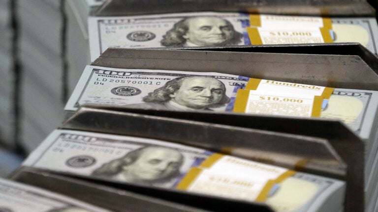 Debt limit -- FILE - Cut stacks of $100 bills make their way down the line at the Bureau of Engraving and Printing Western Currency Facility in Fort Worth, Texas.