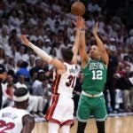 Celtics forward Grant Williams (right) taking a shot over Heat guard Max Strus.