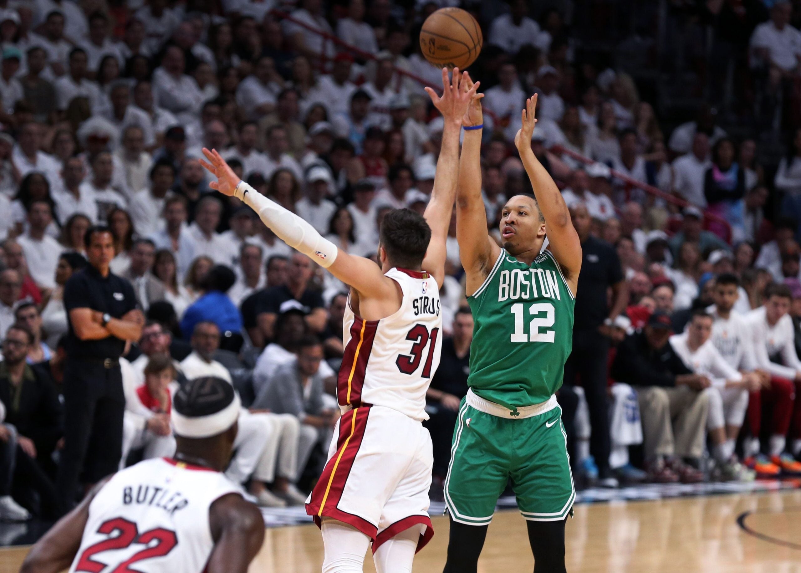 Celtics forward Grant Williams (right) taking a shot over Heat guard Max Strus.