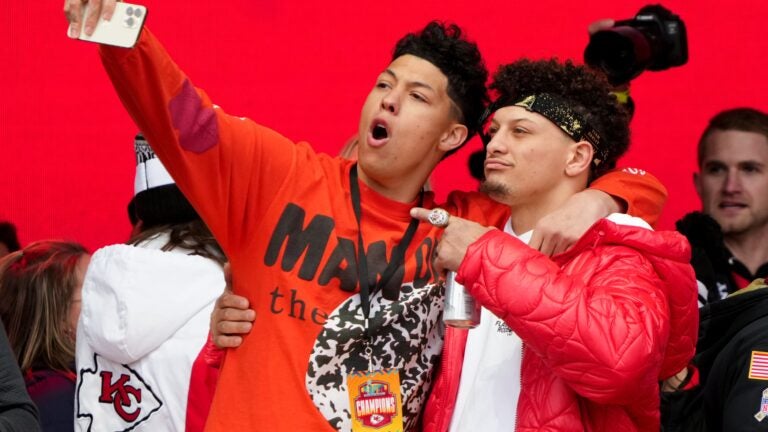 Jackson Mahomes and Patrick Mahomes celebrate on stage during the Kansas City Chiefs' Super Bowl LVII victory parade on Feb. 15, 2023.