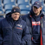 In this Dec. 20, 2018, file photo, New England Patriots head coach Bill Belichick, left, speaks with special teams coach Joe Judge, right, during NFL football practice in Foxborough, Mass.
