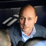Yankees GM Brian Cashman fielding questions from inside the dugout.