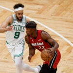 Miami Heat forward Jimmy Butler drives to the basket against Celtics guard Derrick White in the second half of Game 1.