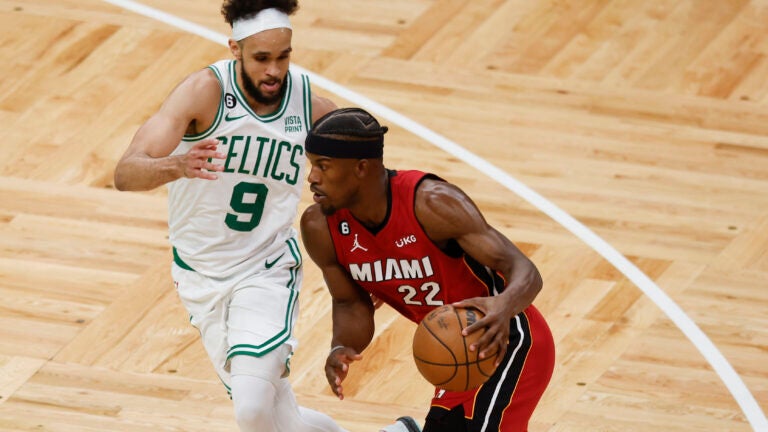 Miami Heat forward Jimmy Butler drives to the basket against Celtics guard Derrick White in the second half of Game 1.