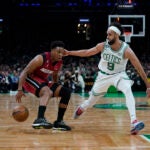 Miami Heat guard Kyle Lowry (7) drives to the basket against Boston Celtics guard Derrick White (9) in the first half of Game 1 of the NBA basketball Eastern Conference finals playoff series in Boston, Wednesday, May 17, 2023.