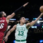 Boston Celtics guard Malcolm Brogdon (13) goes to the basket against Miami Heat forward Caleb Martin (16).