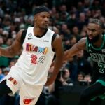 Miami Heat's Jimmy Butler (22) drives past Boston Celtics' Jaylen Brown (7) in overtime during an NBA basketball game, Friday, Dec. 2, 2022, in Boston.