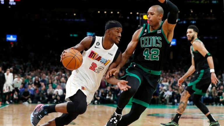 Miami Heat's Jimmy Butler (22) drives past Boston Celtics' Al Horford (42) during the second half of an NBA basketball game Friday, Dec. 2, 2022, in Boston.