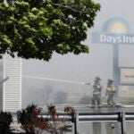 Firefighters douse the smoky remnants of a Days Inn in Kittery, Maine.