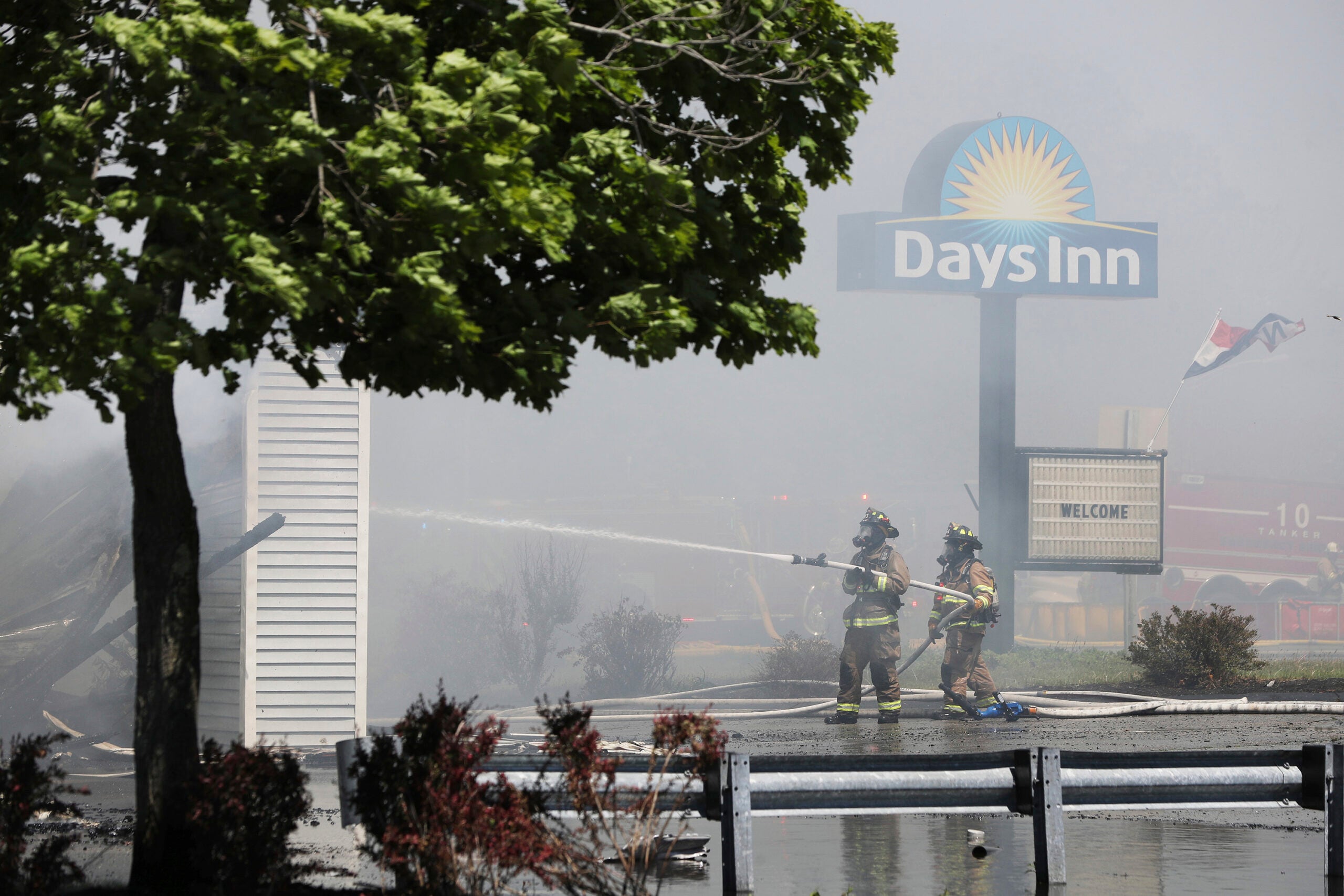 Firefighters douse the smoky remnants of a Days Inn in Kittery, Maine.