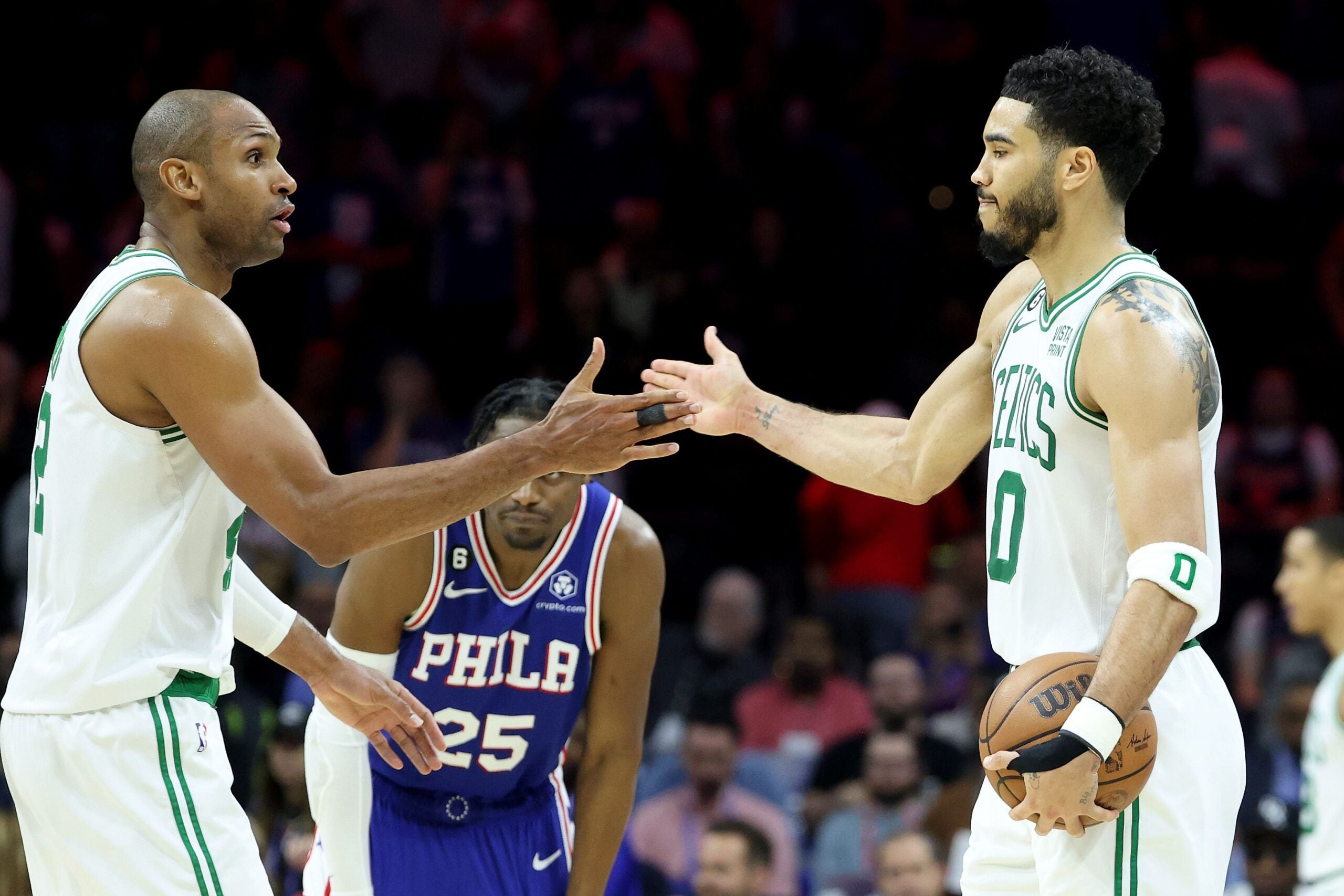 Al Horford #42 and Jayson Tatum #0 of the Boston Celtics celebrate after defeating the Philadelphia 76ers in game six in the Eastern Conference Semifinals in the 2023 NBA Playoffs at Wells Fargo Center on May 11, 2023 in Philadelphia, Pennsylvania.