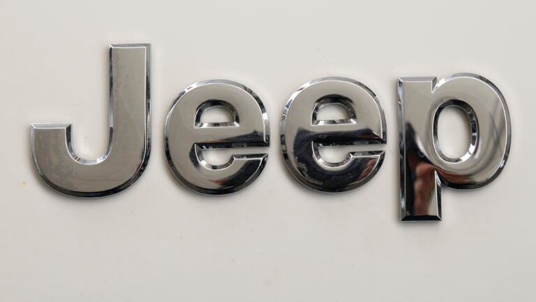 FILE - This is the Jeep logo on the front end of a Jeep Cherokee on display at the Pittsburgh International Auto Show in Pittsburgh Thursday, Feb. 11, 2016. Stellantis is telling owners of nearly 220,000 Jeep Cherokee SUVs worldwide, Tuesday, May 16, 2023, to park them outdoors and away from other vehicles because the power liftgates can catch fire even when the engines are off. The company is recalling certain Jeep Cherokees from the 2014 through 2016 model years. (AP Photo/Gene J. Puskar, File)