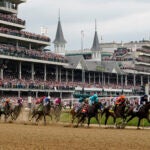 Horses come through the first turn during the 149th running of the Kentucky Derby horse race at Churchill Downs Saturday, May 6, 2023, in Louisville, Ky.