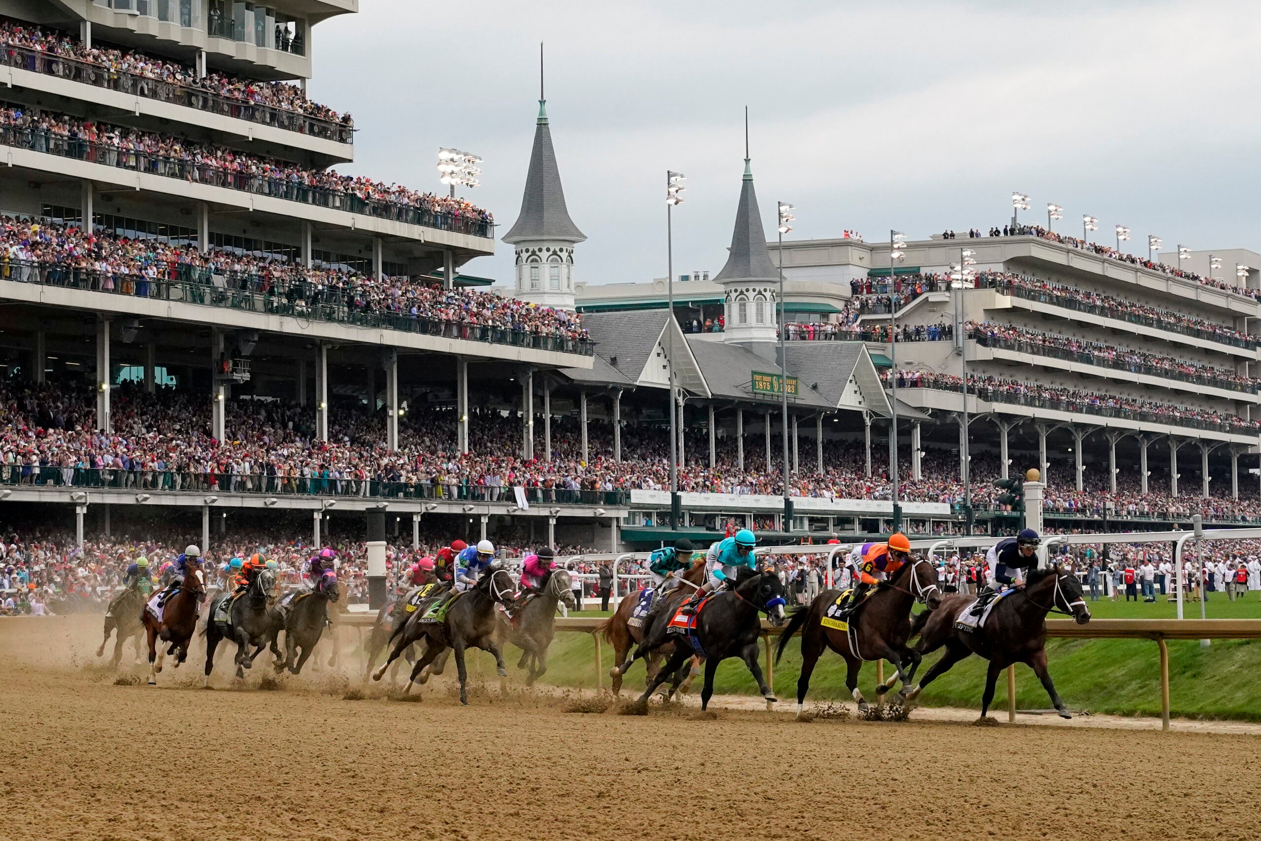 Horses come through the first turn during the 149th running of the Kentucky Derby horse race at Churchill Downs Saturday, May 6, 2023, in Louisville, Ky.