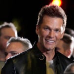 NFL quarterback Tom Brady, a cast member and producer of "80 for Brady," looks down the carpet at the premiere of the film, Tuesday, Jan. 31, 2023, at the Regency Village Theatre in Los Angeles.