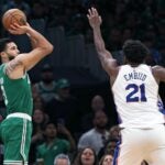 Celtics forward Jayson Tatum takes a three over 76ers center Joel Embiid.