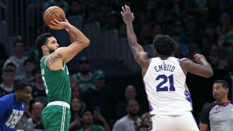 Celtics forward Jayson Tatum takes a three over 76ers center Joel Embiid.