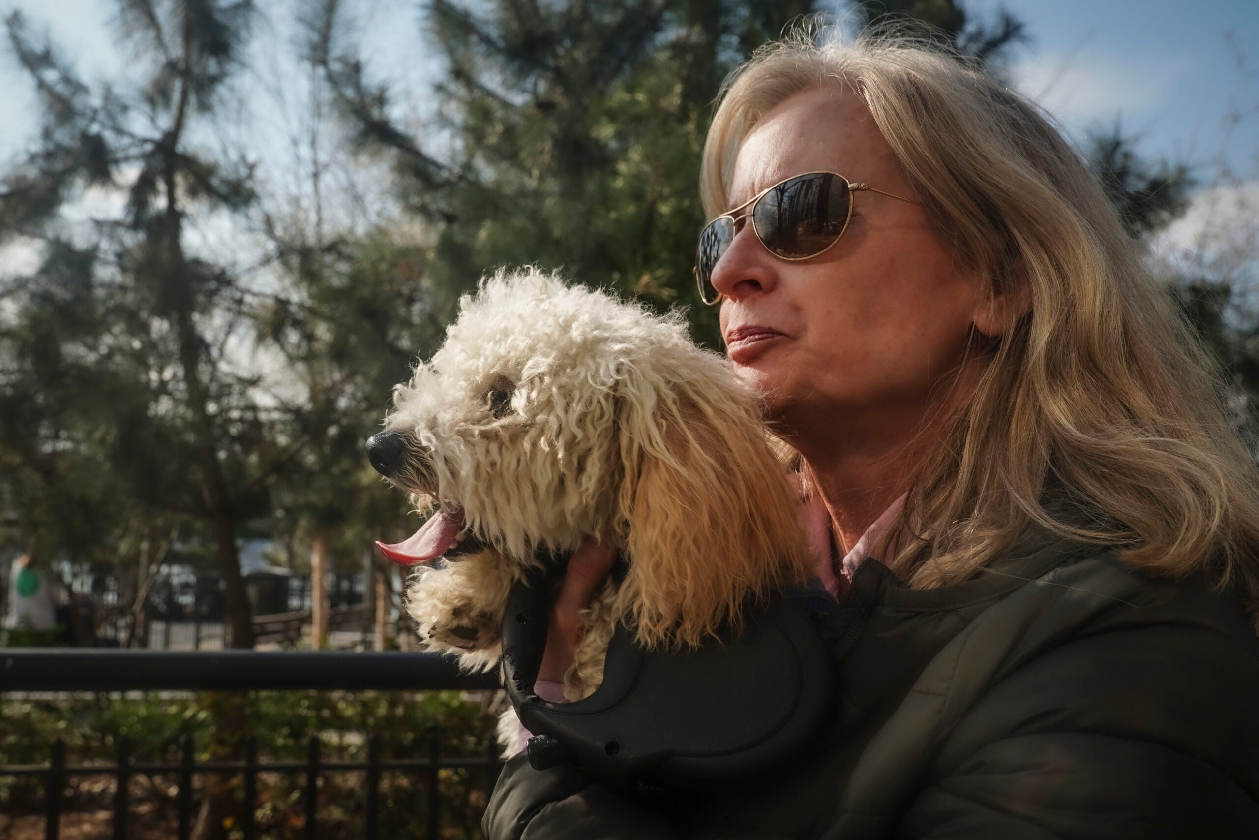 Colleen Briggs holds her 8-month-old poodle named Bondi, during a walk a park near their home, Thursday April 6, 2023, in New York.