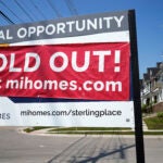 A for-sale sign with a sold out banner on top of it is used to illustrate a story on the average mortgage rate.