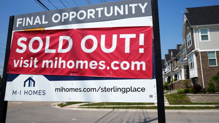 A for-sale sign with a sold out banner on top of it is used to illustrate a story on the average mortgage rate.
