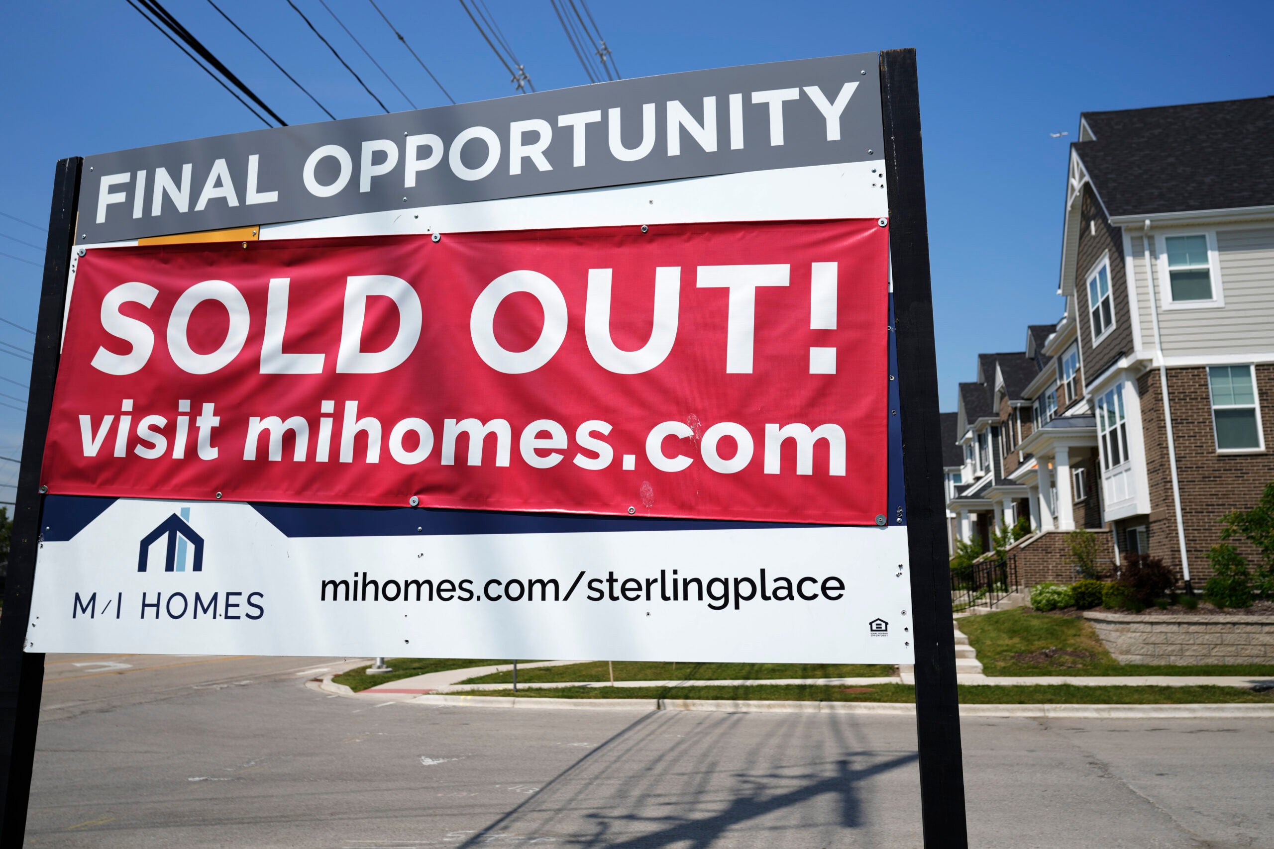 A for-sale sign with a sold out banner on top of it is used to illustrate a story on the average mortgage rate.