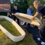Director Lonneke Westhoff, right, and founder Bob Hendrikx, left, of Dutch startup Loop Biotech display one of the cocoon-like coffins, grown from local mushrooms and up-cycled hemp fibres, designed to dissolve into the environment amid growing demand for more sustainable burial practices, in Delft, Netherlands.