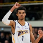 Boulogne-Levallois' Victor Wembanyama celebrates after a dunk against Lyon-Villeurbanne during a basketball game in Levallois, France