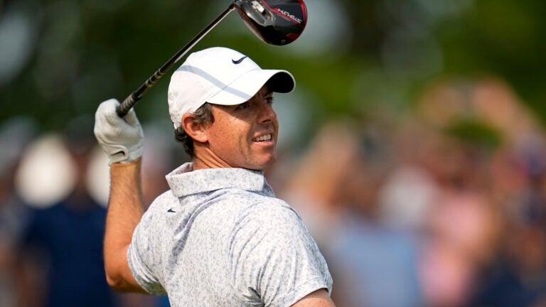 Rory McIlroy, of Northern Ireland, watches his tee shot on the 14th hole during the final round of the PGA Championship golf tournament at Oak Hill Country Club.