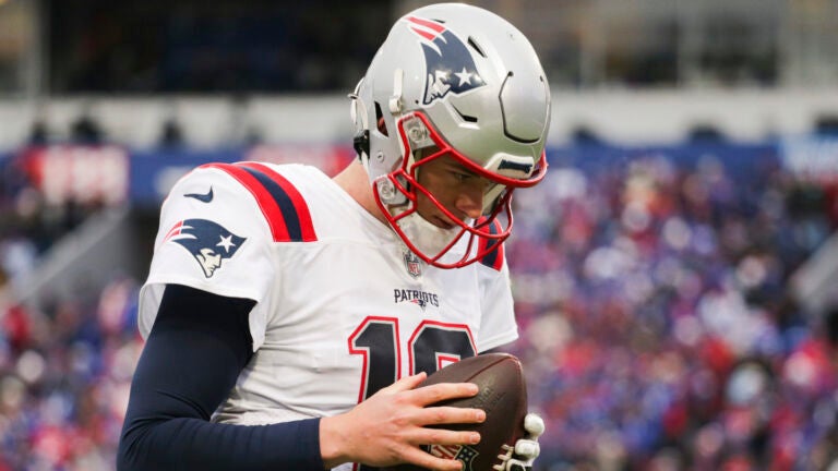 New England Patriots quarterback Mac Jones (10) warms up on the sideline during the first half of an NFL football game against the Buffalo Bills on Sunday, Jan. 8, 2023, in Orchard Park, N.Y.