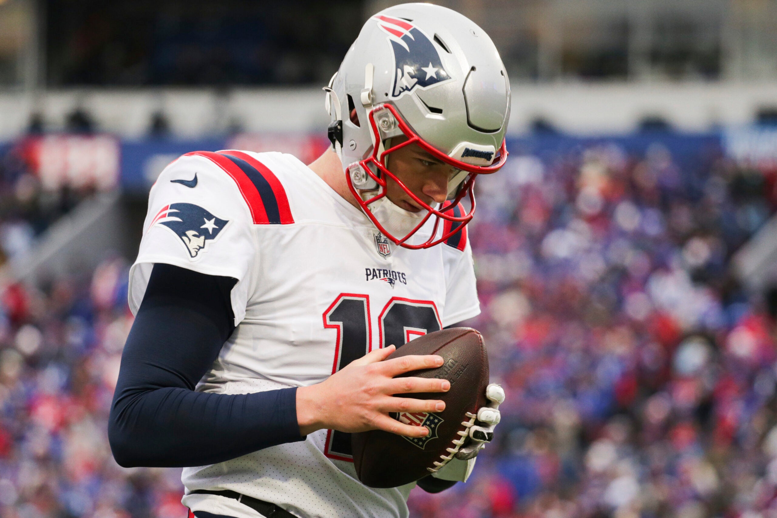 New England Patriots quarterback Mac Jones (10) warms up on the sideline during the first half of an NFL football game against the Buffalo Bills on Sunday, Jan. 8, 2023, in Orchard Park, N.Y.