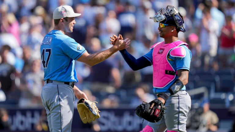 Tampa Bay Rays relief pitcher Jason Adam (47) celebrates with catcher Christian Bethancourt (14) after closing the ninth inning of a baseball game against the New York Yankees.